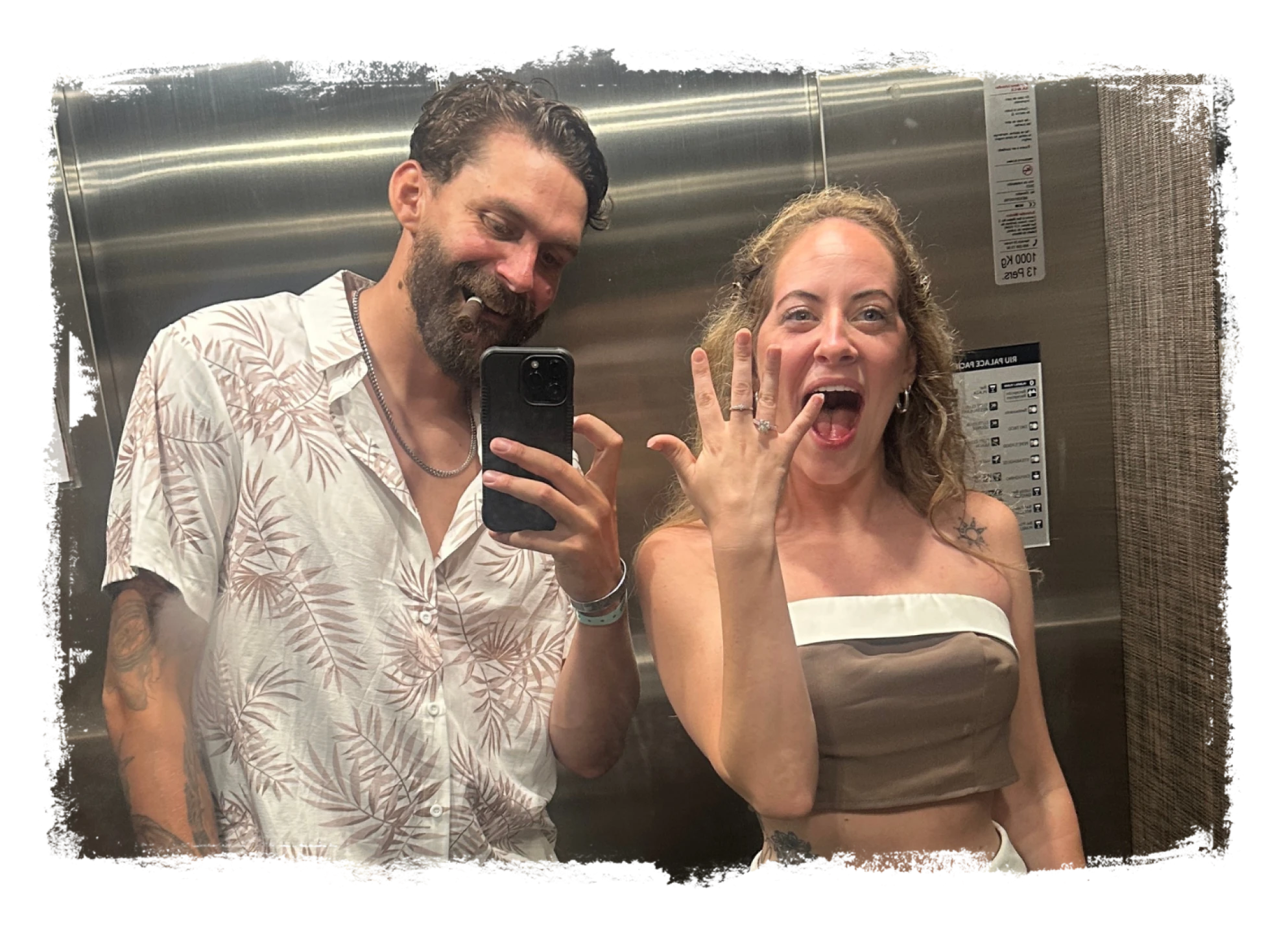 Aaron and Logan smiling and holding hands